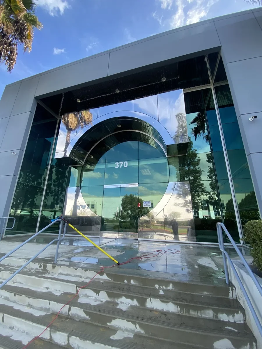 Clean storefront windows reflecting the sky and surroundings